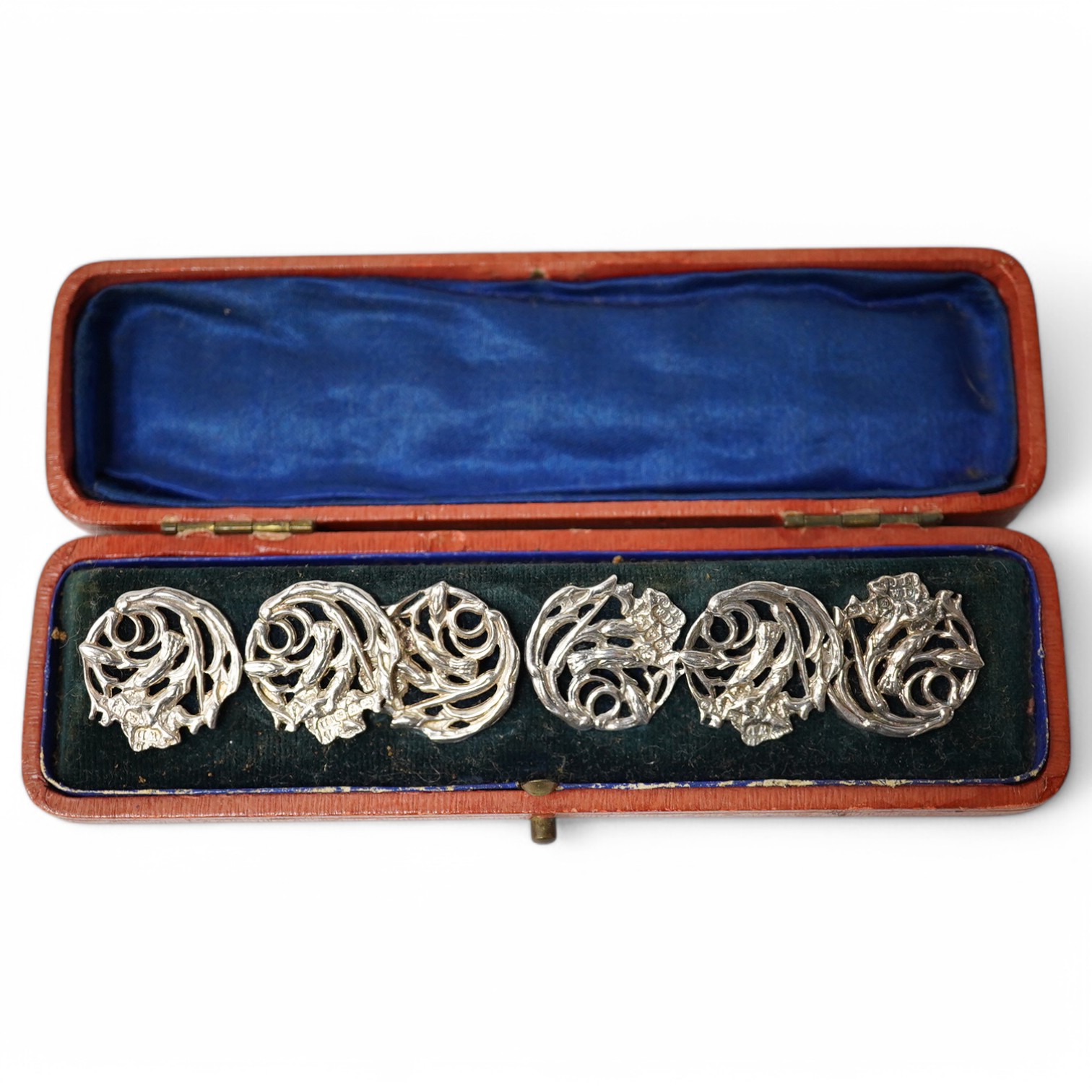 An Edwardian cased set of 6 Art Nouveau silver buttons, cast with stylised scrolling flowers, James Deakin & Sons, Chester 1904, 20mm. Condition - good